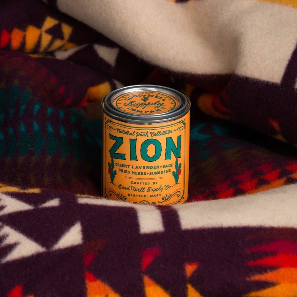 A tin of Good &amp; Well Supply Co.&#39;s Zion National Park Candle - Half Pint sitting on a blanket.