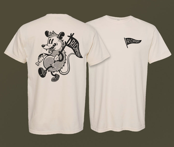 Two grey Richmond Possum River Rat shirts by The Wild Wander are displayed. The front features a small "Richmond" logo, while the back showcases a cartoon rat holding a Richmond pennant with "Richmond" written on it.