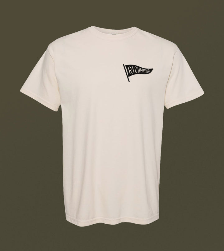 This grey Richmond Possum River Rat Shirt by The Wild Wander showcases a small black "Richmond" pennant graphic on the left chest, beautifully contrasted against a dark green background.