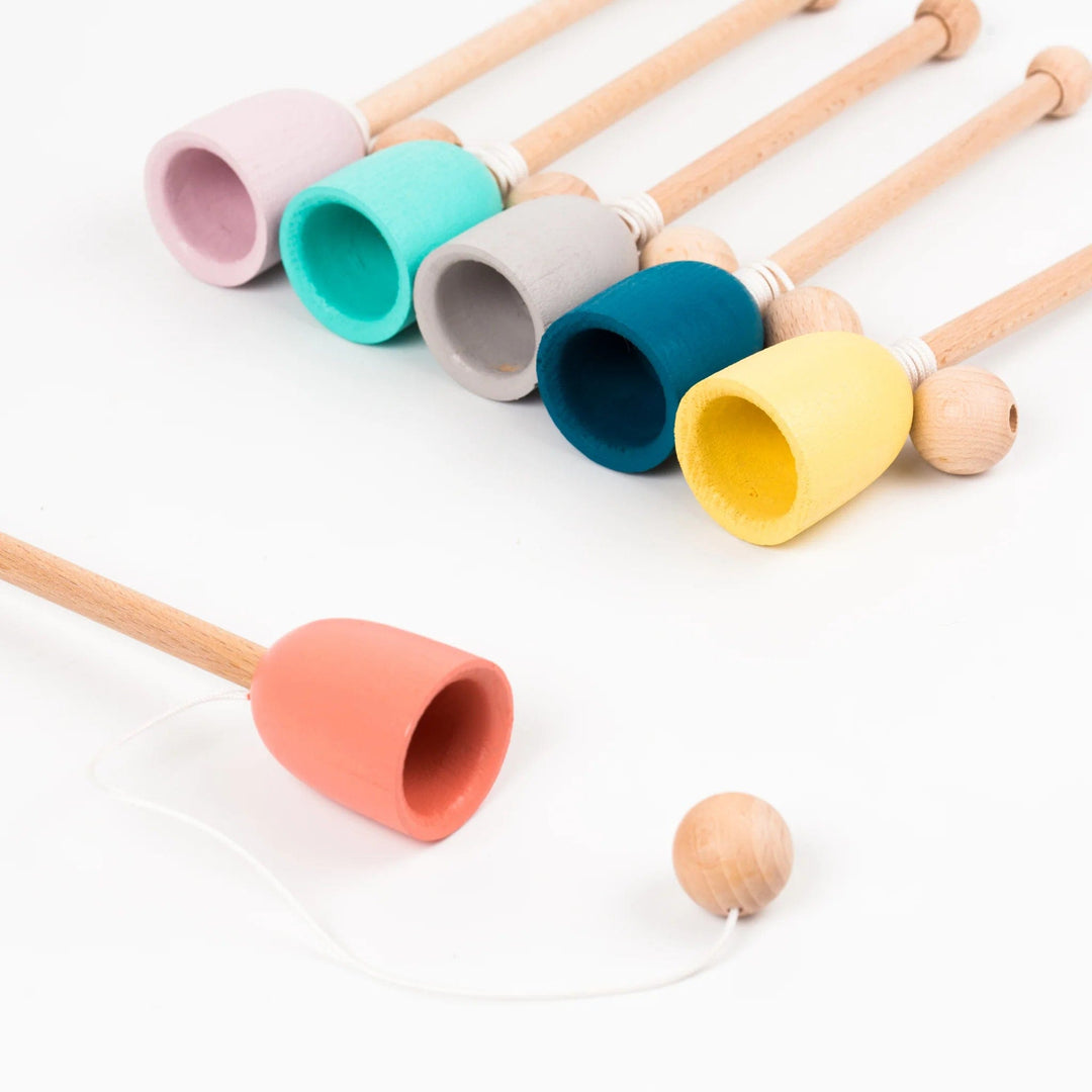 A set of Me & Mine Cup & Ball Toys with a wooden ball.