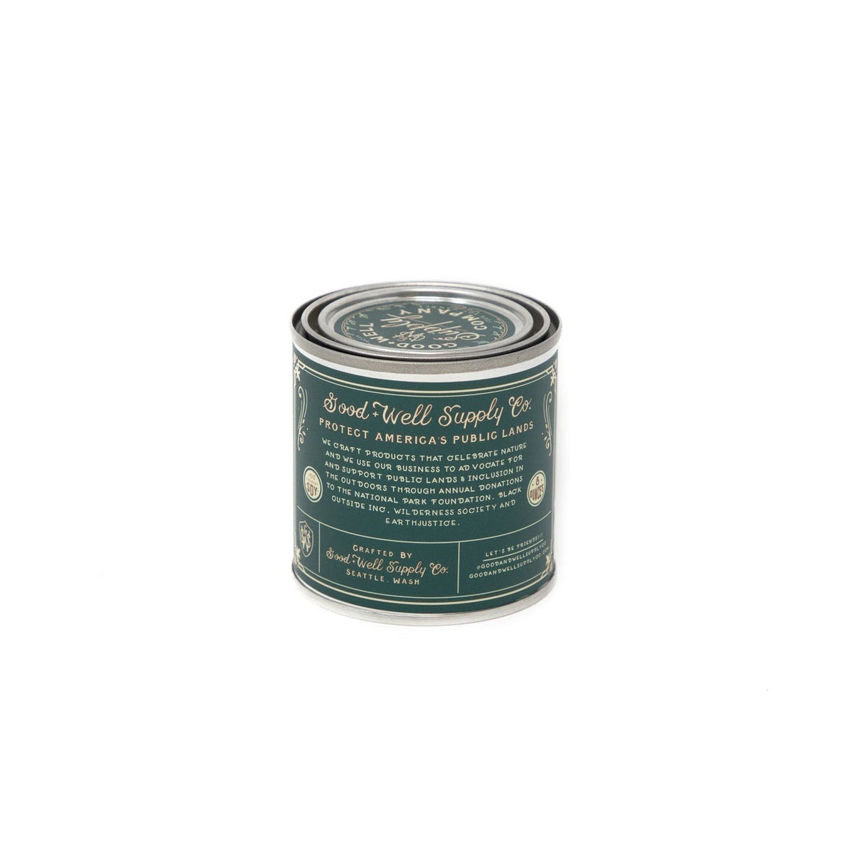 A green tin with a label on it, containing the Appalachian Trail Candle from A Good &amp; Well Supply Co.