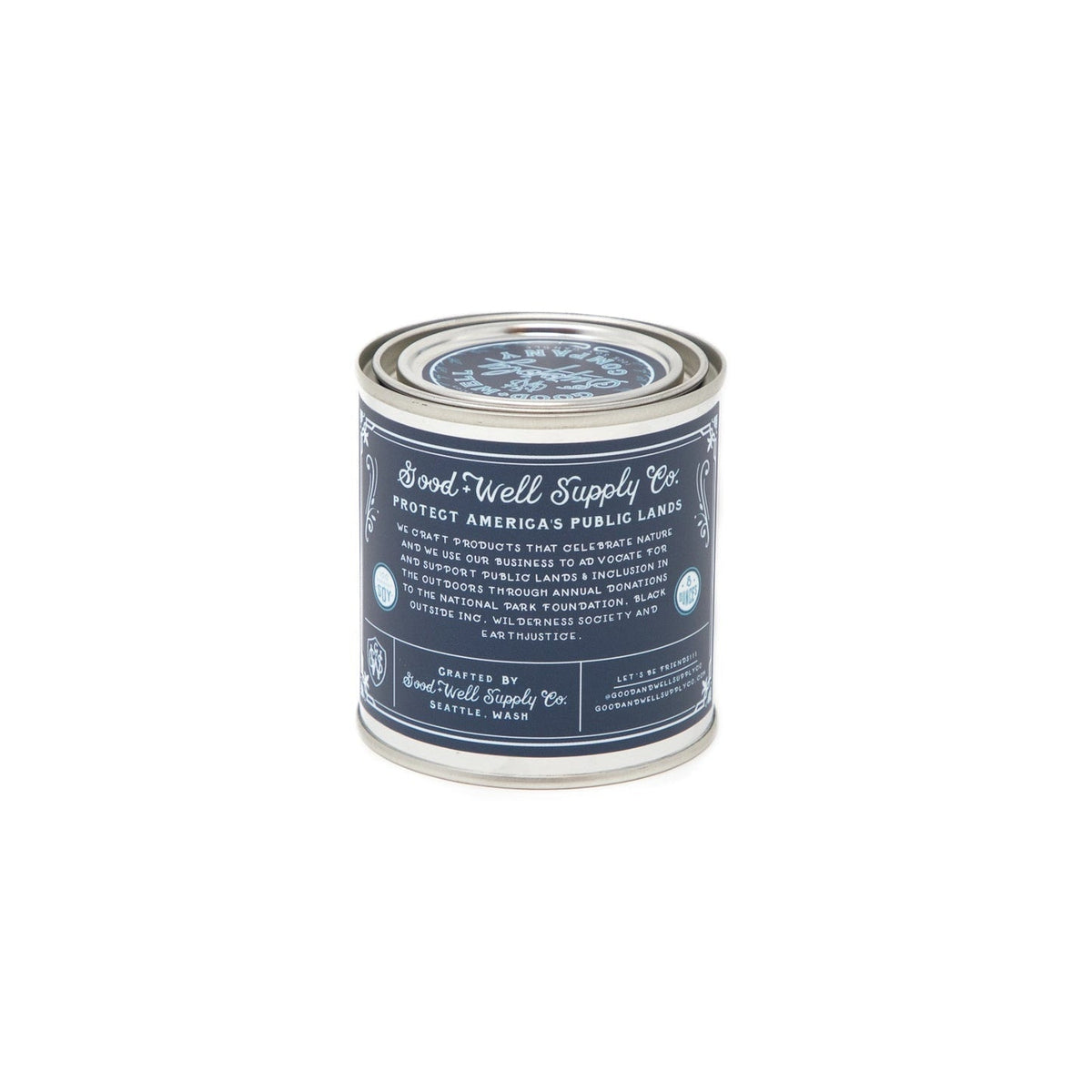 A Cape Hatteras - National Seashores Candle with a blue label on it by Good &amp; Well Supply Co.