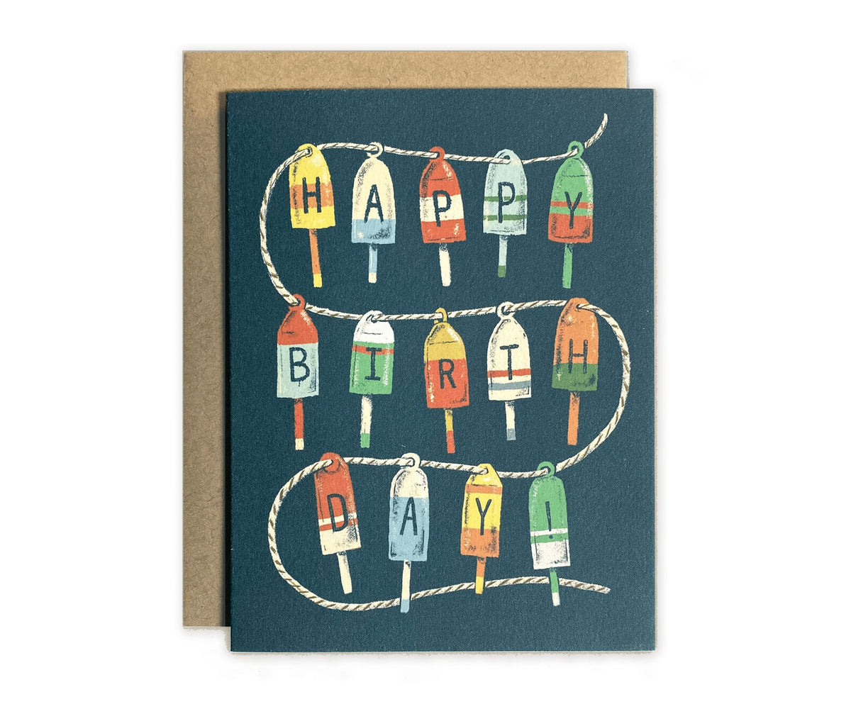 A Happy Birthday Buoys Greeting Card with a bunch of boat floats on it, made by The Wild Wander brand.