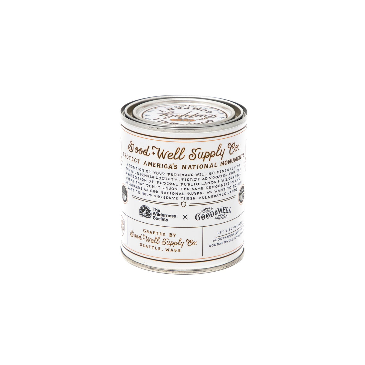 A tin with a white label on it, containing the Cascade-Siskyou Candle by Good &amp; Well Supply Co.