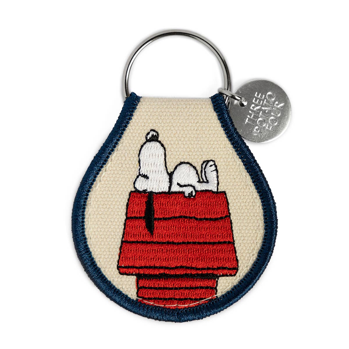 A Snoopy Keychain from Three Potato Four featuring Snoopy&#39;s doghouse.