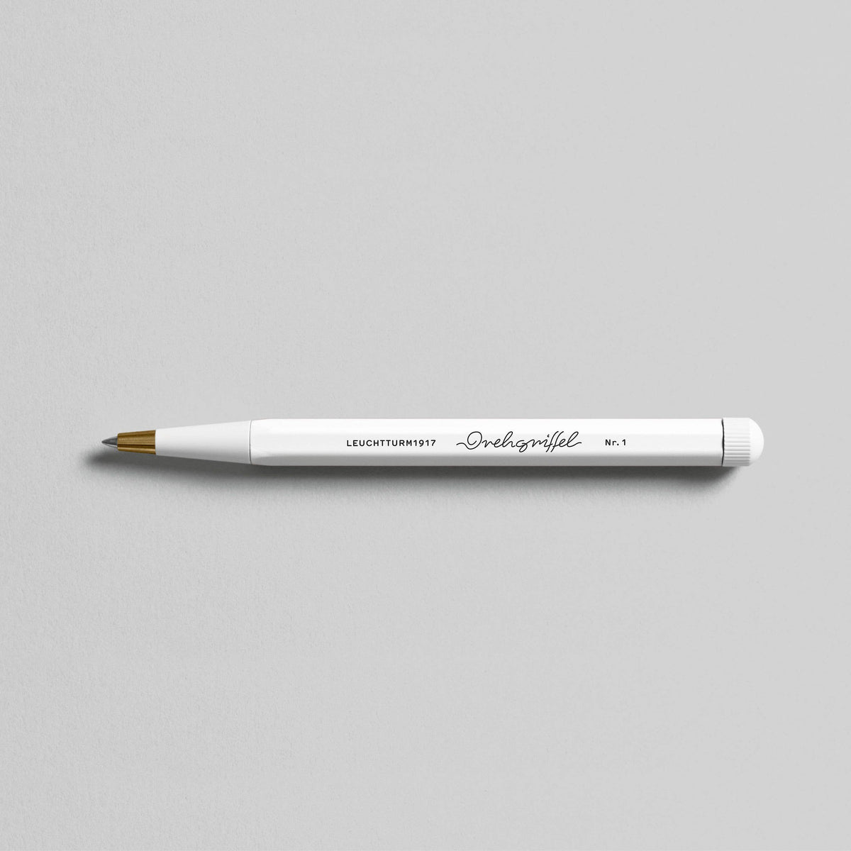 A LEUCHTTURM1917 Drehgriffel Nr. 1 - Gel Pen: White with a gold tip, Germany&#39;s finest writing instrument, on a gray surface.