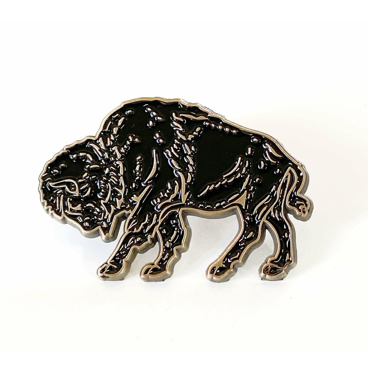 A black and gold Bison Enamel Pin by The Wild Wander.
