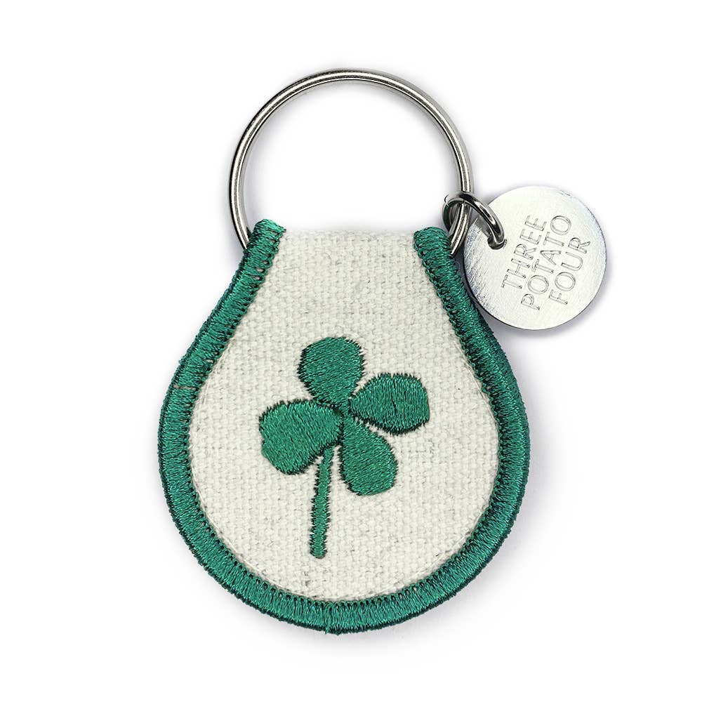 A Patch Keychain - Lucky Clover by Three Potato Four with a shamrock on it.