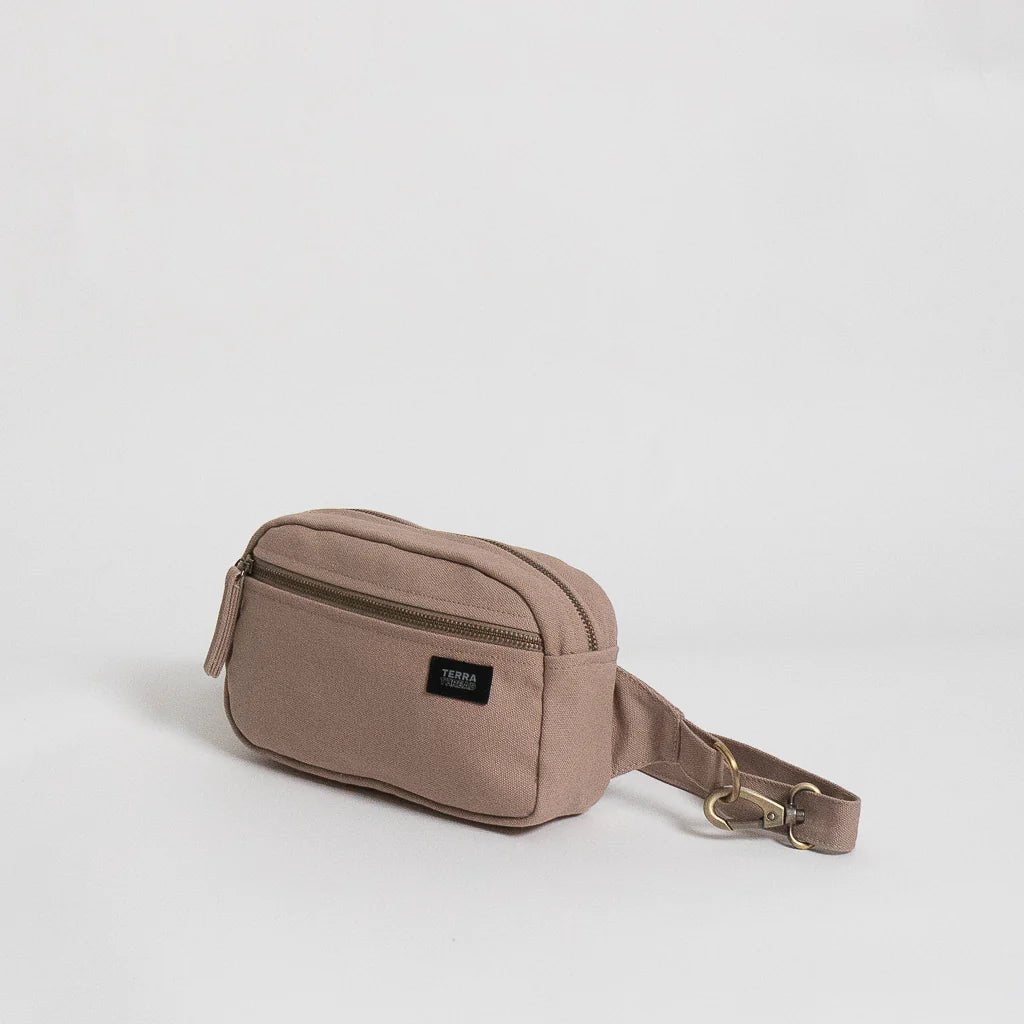 A Terra Thread Cadera Fanny Pack - Sand Dune with a strap.