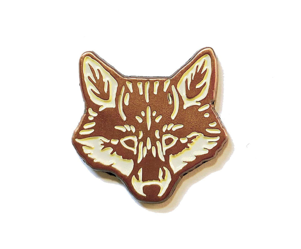 A Red Fox Enamel Pin with The Wild Wander brand on it.